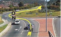 category intersections - You are in the right hand lane and are planning to go straight ahead through this roundabout. When should you signal left to exit the roundabout?