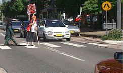 category pedestrians - You approach a crossing and see the scene in the picture. You should: